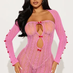 Front view of a fierce pink lace mini dress with cutouts and long sleeves.